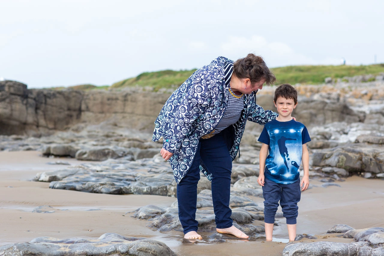 foster carer and boy on beach